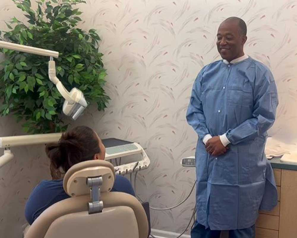 Whittier Palm Dental Dentist Patient Interaction 73513 Dentist in blue gown smiling at patient at Whittier Palm Dental in Montebello, CA
