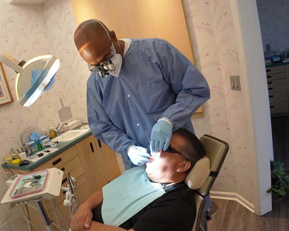 Whittier Palm Dental Dental Examination 74290 Dentist treating patient at Whittier Palm Dental in Montebello, CA