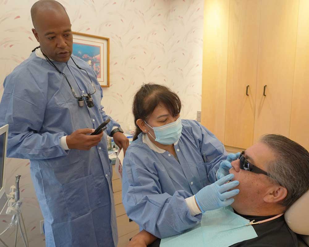 Whittier Palm Dental Dental Examination 37433 Dentist and assistant treating patient at Whittier Palm Dental in Montebello, CA